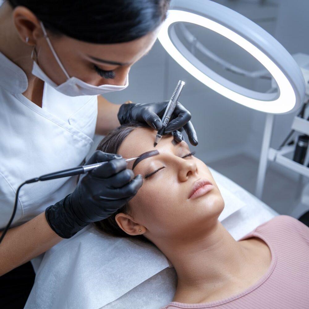 kosmetyczka wykonuje makijaż brwi